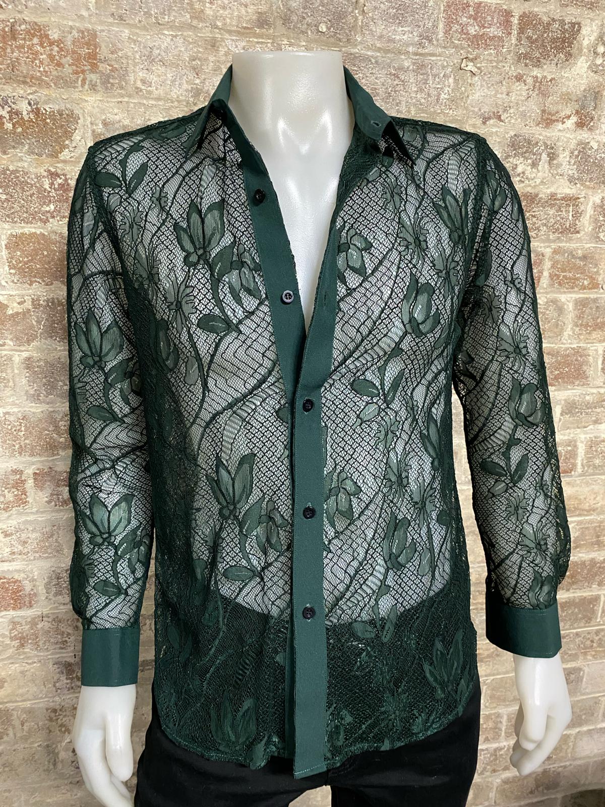 Green lace shirt on a mannequin against a brick wall background
