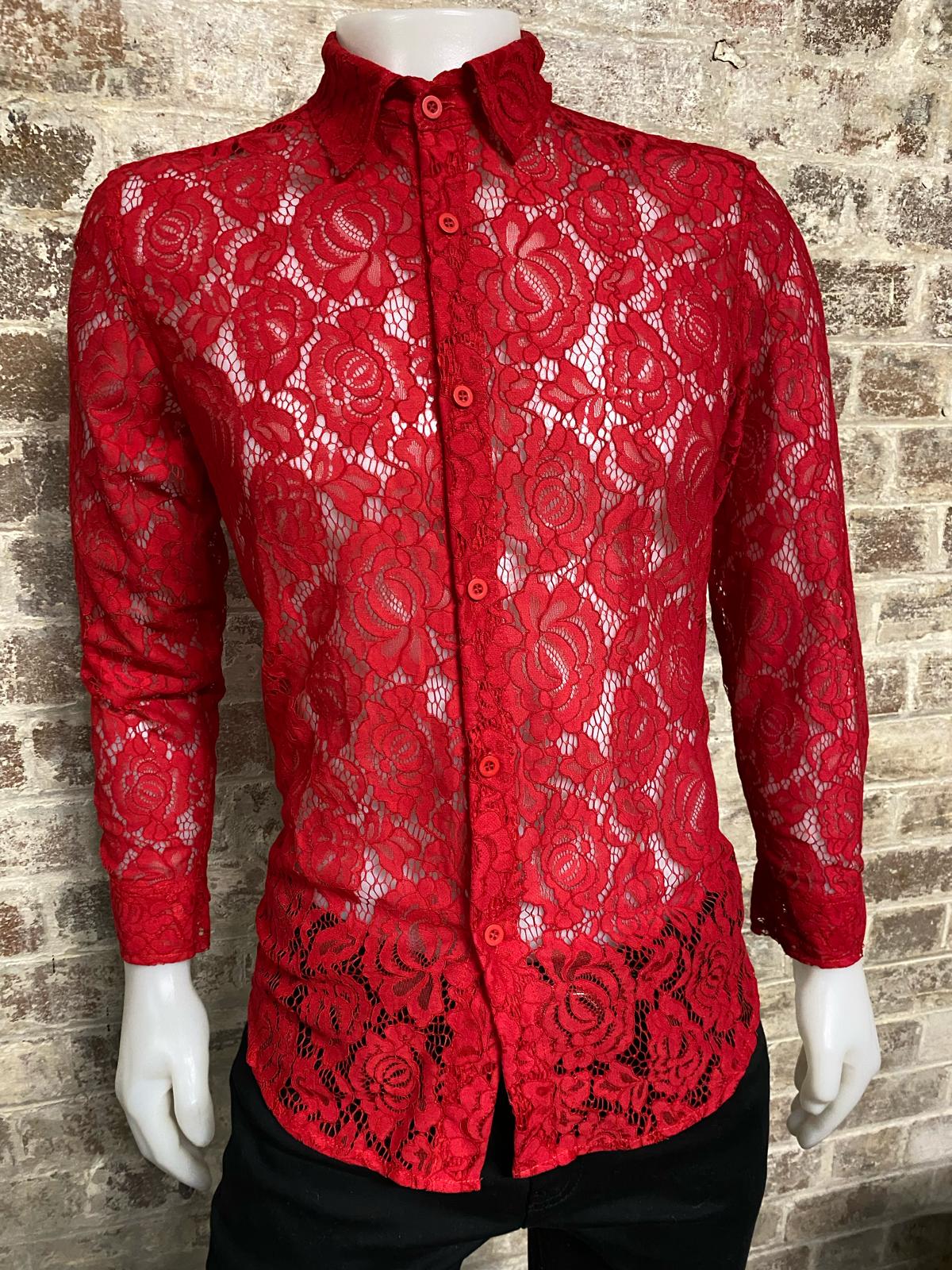 Red floral lace shirt on a mannequin against a brick wall background