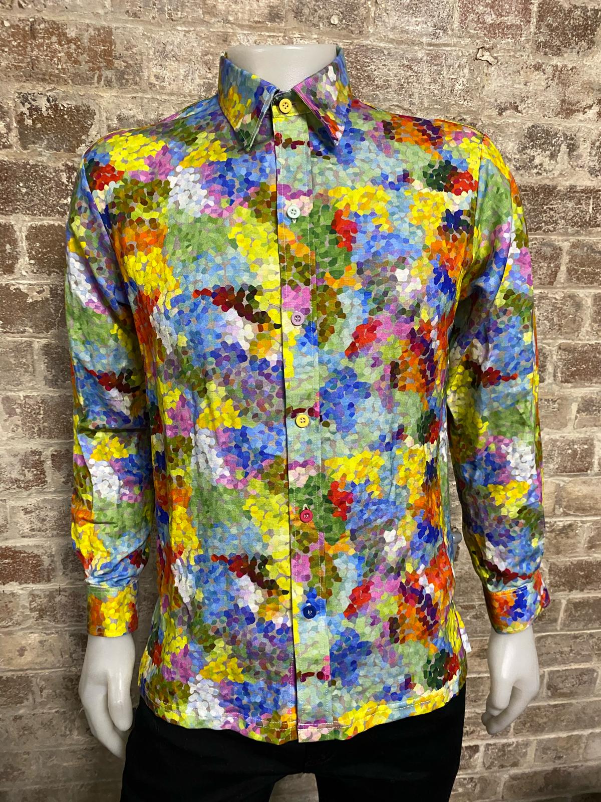 Colorful patterned shirt on a mannequin against a brick wall background
