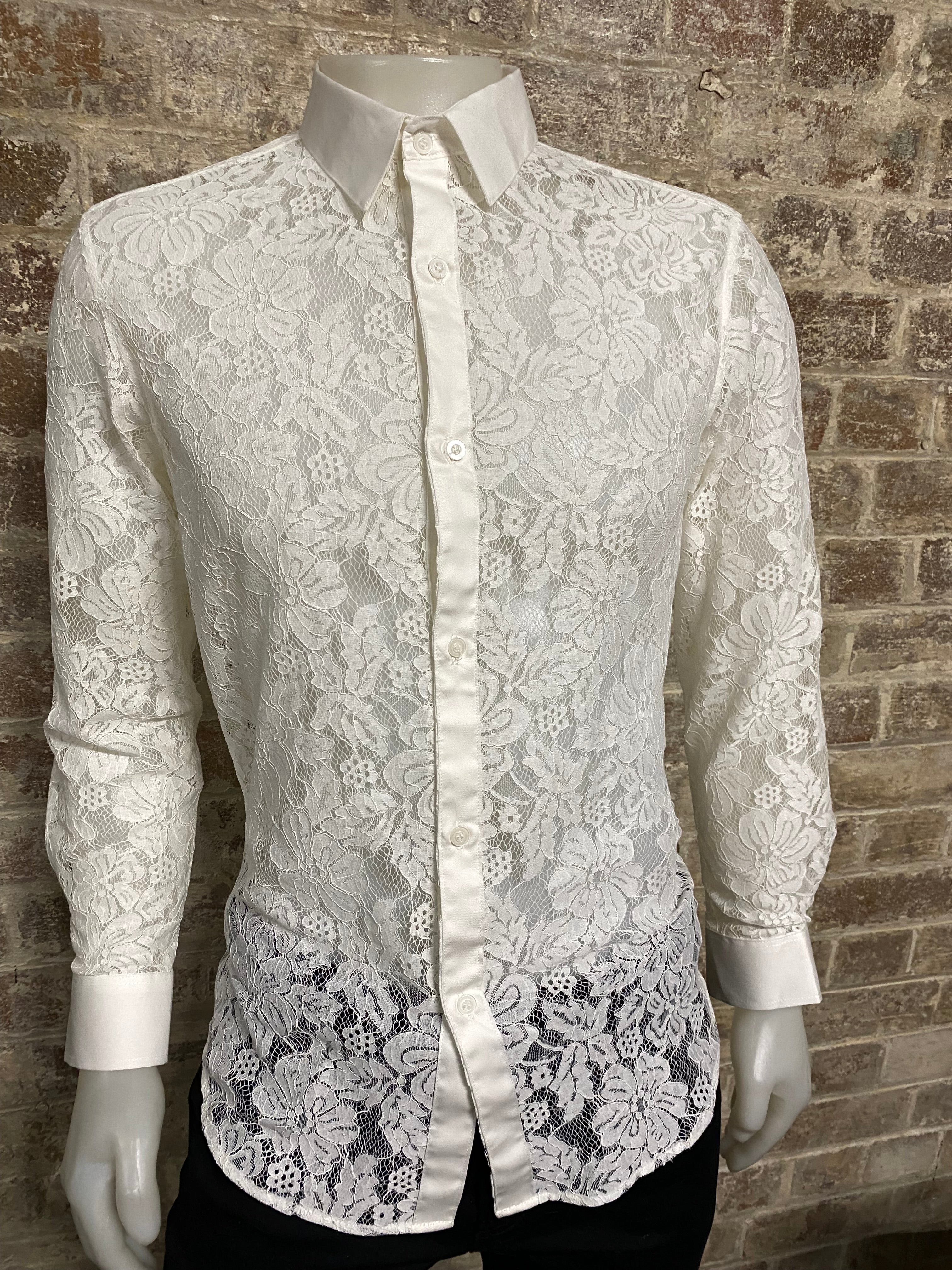 Mannequin wearing a white lace outfit on a brick floor