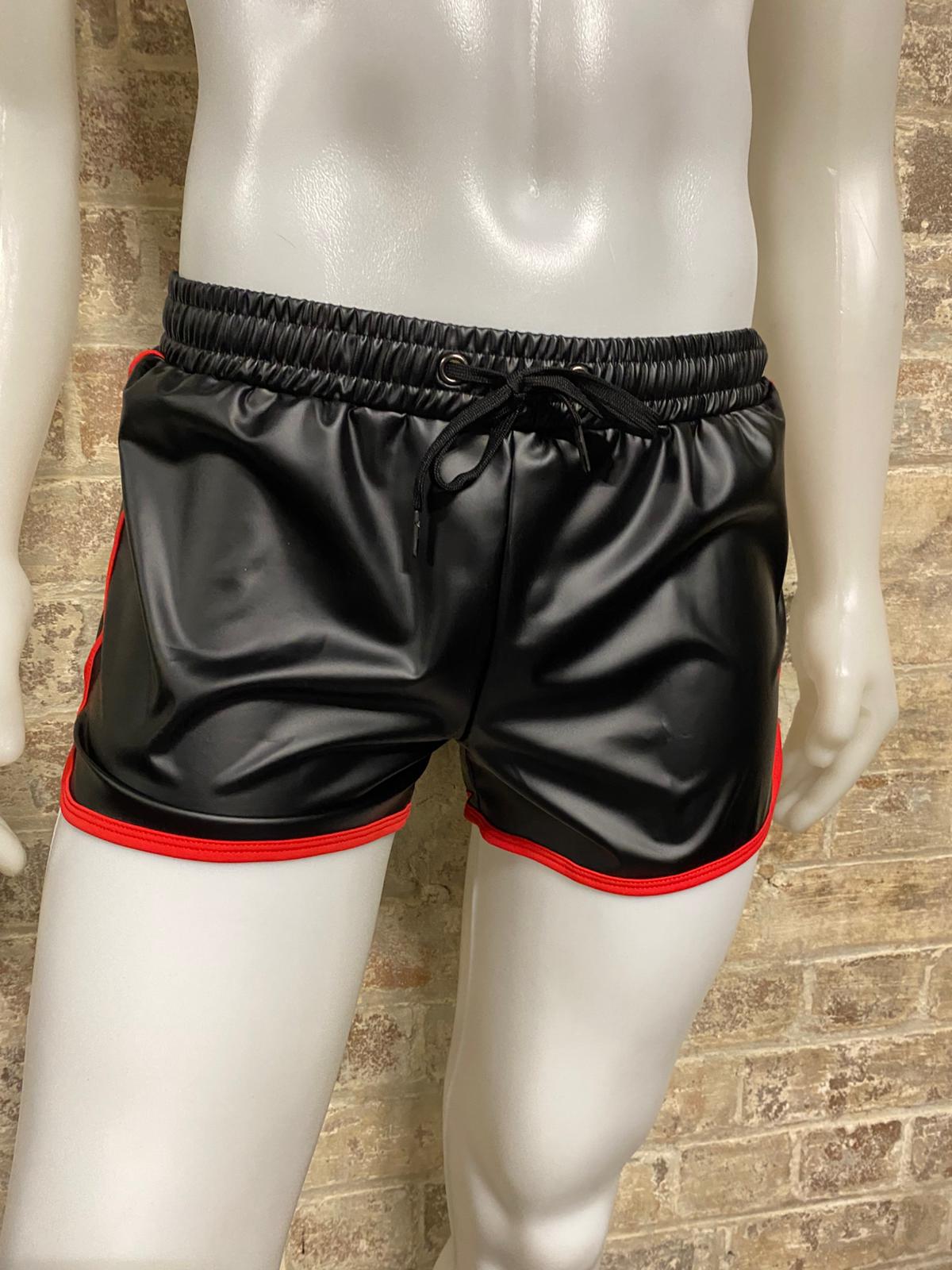 Shorts on manequin in front of brick wall