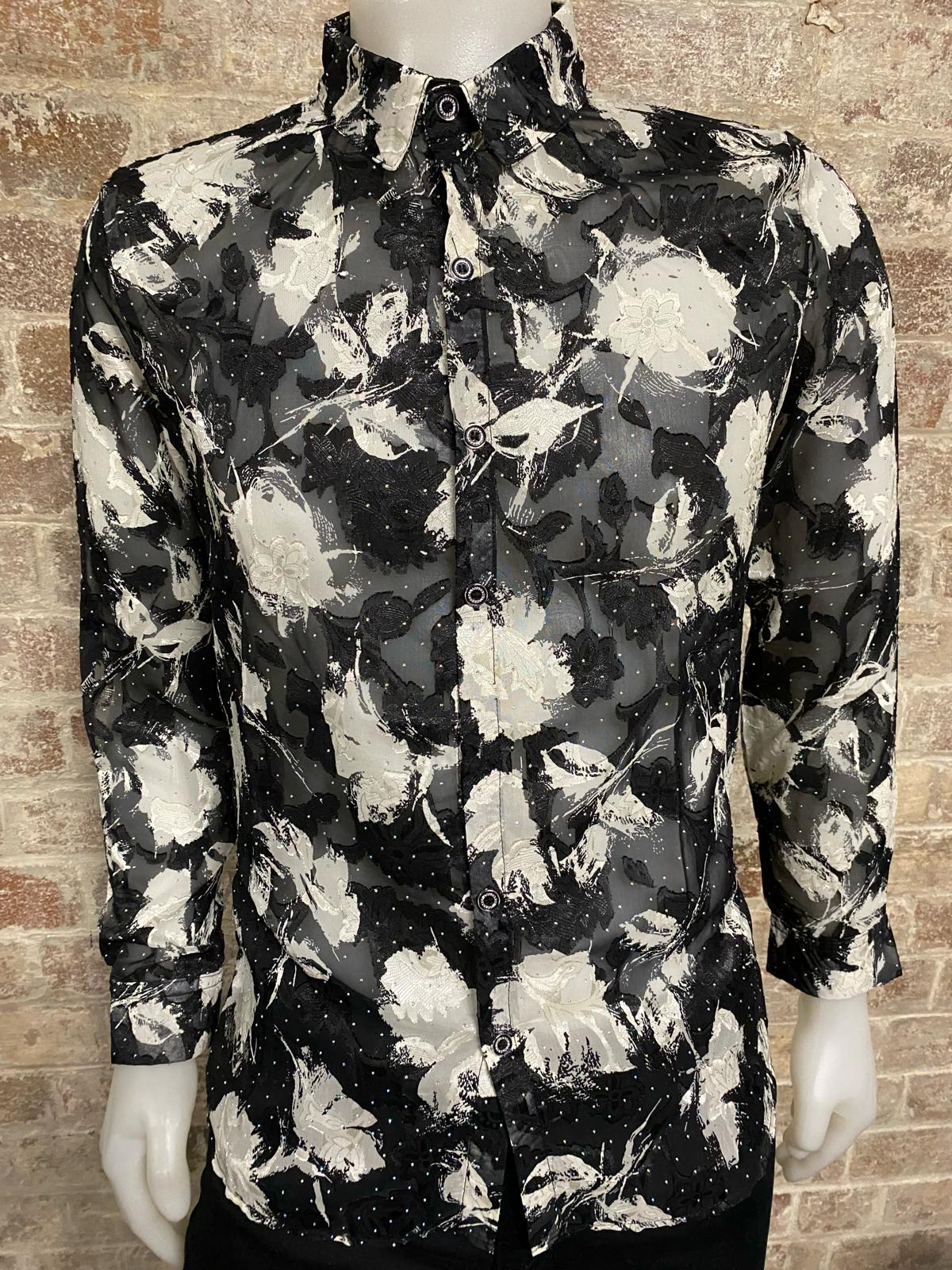 Floral patterned shirt on a mannequin against a brick wall background