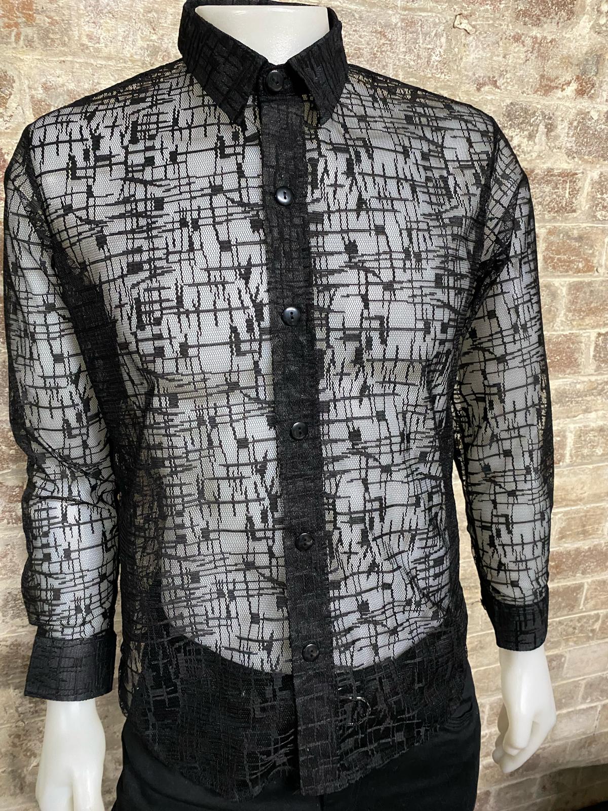 Black spider patterned shirt on a mannequin against a brick wall.