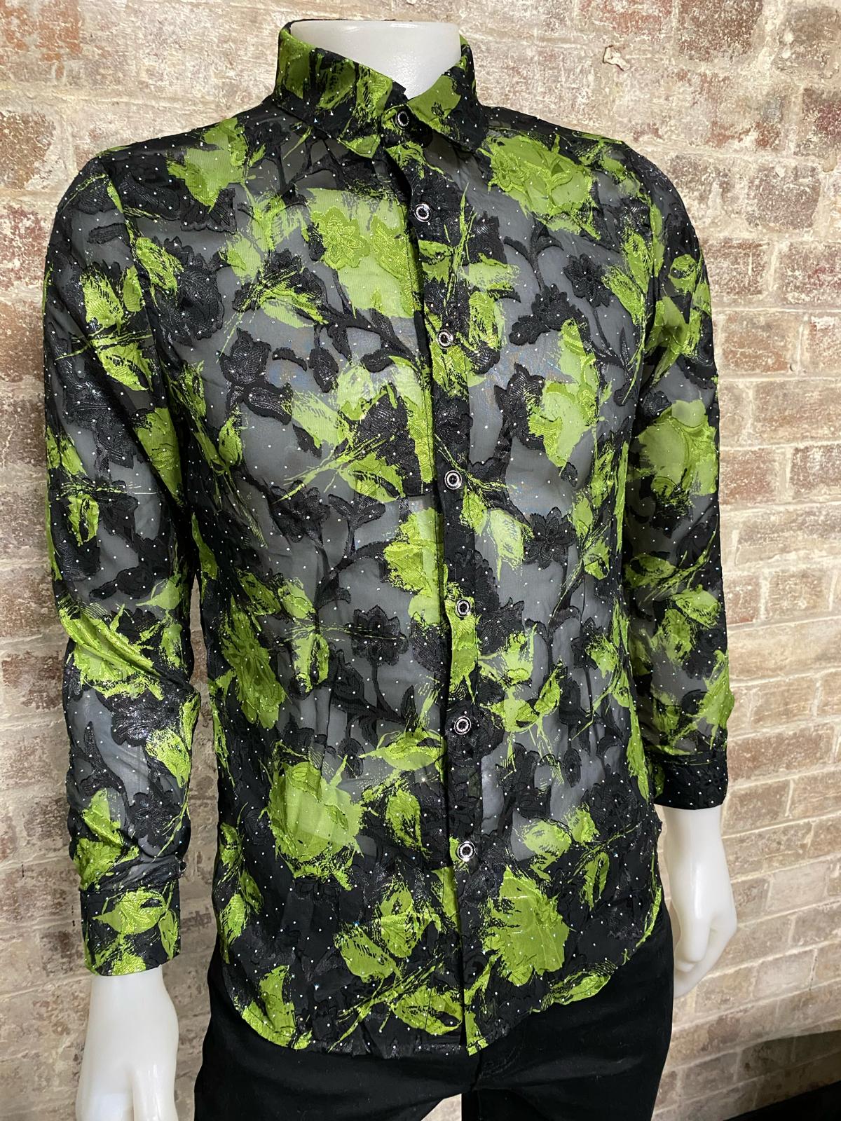 Green and black patterned shirt on a mannequin against a brick wall.