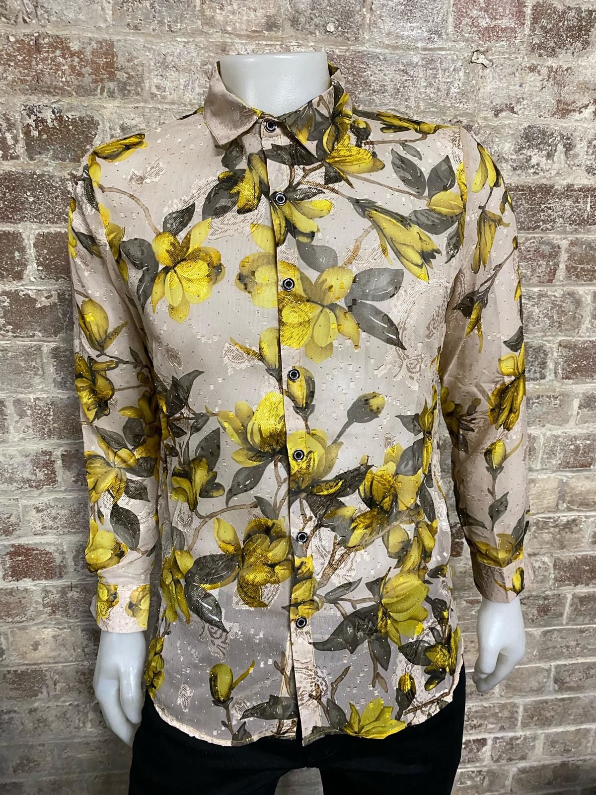 Floral patterned shirt on a mannequin against a brick wall background